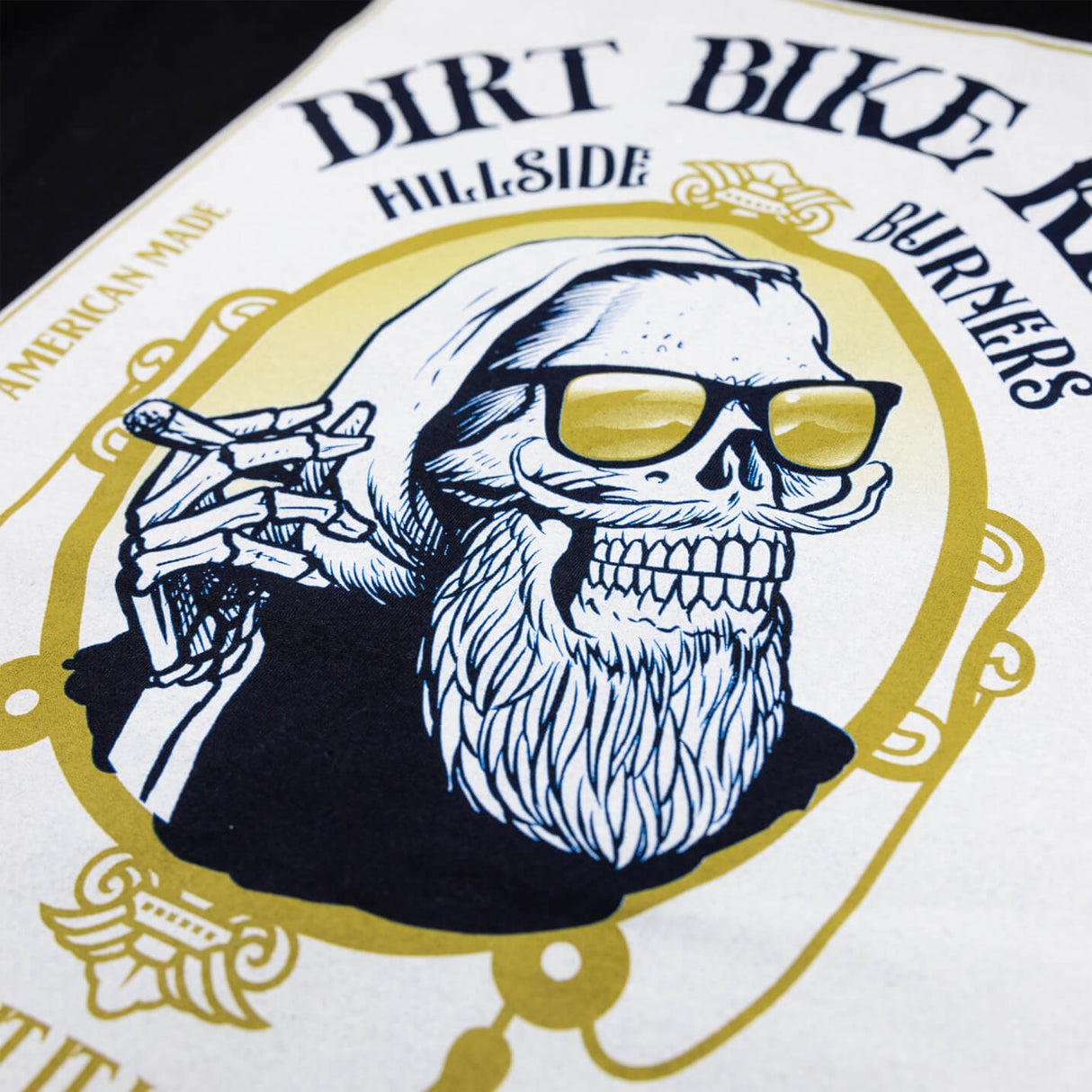 White tall tee back graphic with skull and sunglasses in a gold crest.