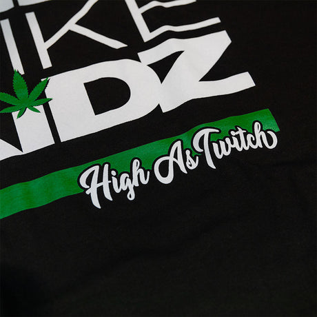 Black kids graphic T-shirt close-up of green stripe with "High As Truth" script
