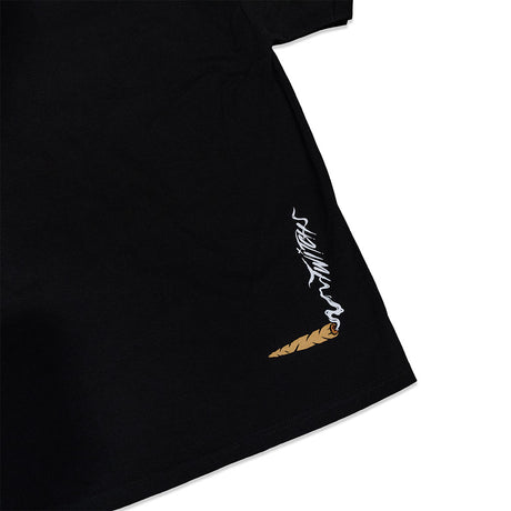 Black T-shirt side seam view with white flame graphic and small brown icon