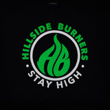 Black Hillside Burners T-shirt close-up of green-and-white circular logo graphic