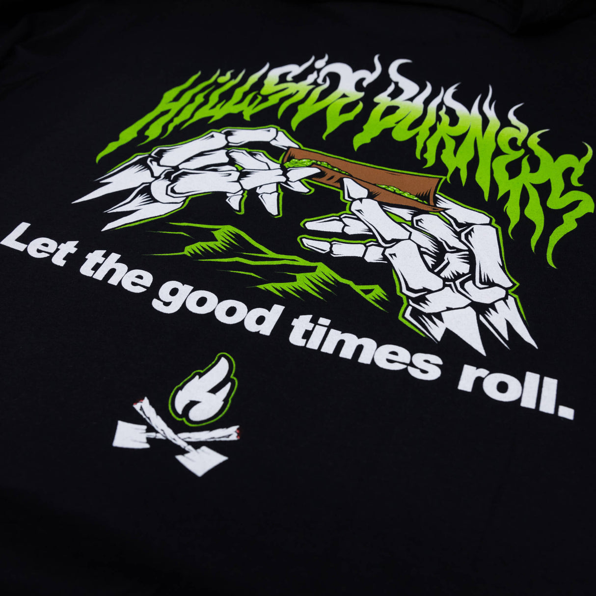 Black T-shirt front close-up of green flame band and 'Let the good times roll'