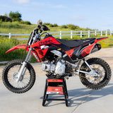 Honda CRF 110 dirt bike in red and black with graphics, front view on stand