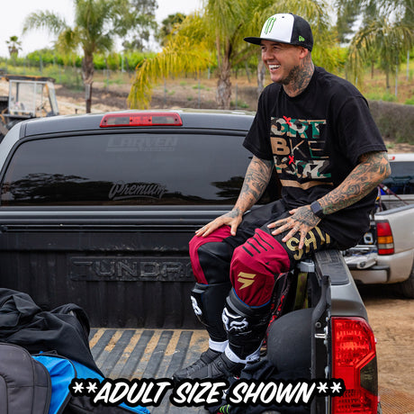 Black youth premium tee worn by rider; front shows camo Dirt Bike graphic