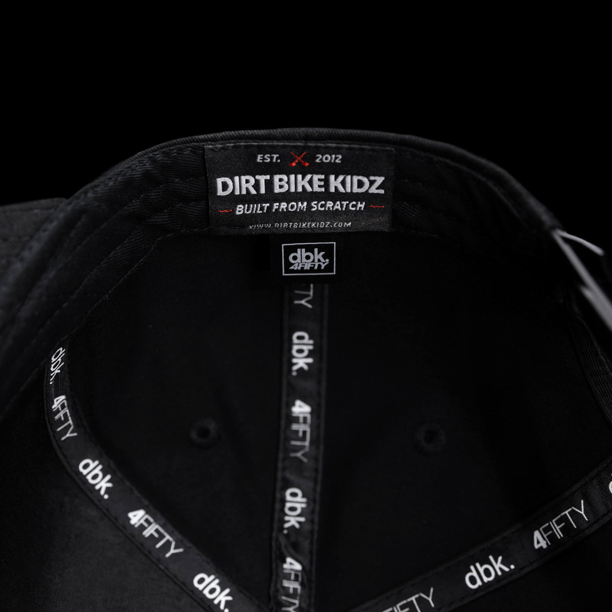 Black snapback cap interior with “DIRT BIKE KIDZ” label and dBK 4FITY trim