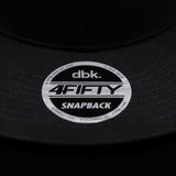 Snapback brim sticker showing “dbk 4FITY SNAPBACK” on black cap