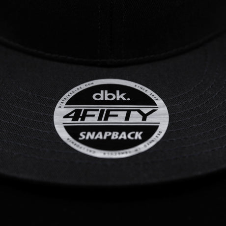 Snapback brim sticker showing “dbk 4FITY SNAPBACK” on black cap