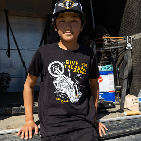 Youth boy wearing a black T-shirt with 'Give Em The Smoke' motocross graphic on the front