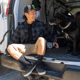 Charcoal plaid flannel button-up shirt on person seated