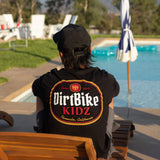 Premium tall tee, black, with DirtBike KIDZ oval back logo graphic worn by person