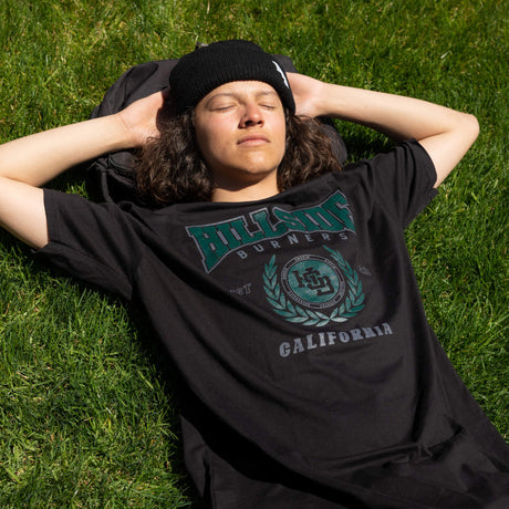 Black varsity tee with green front crest and “California” text
