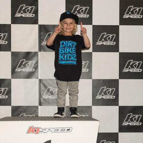 Youth tee worn at event: black shirt with blue “DIRT BIKE KIDZ” front graphic