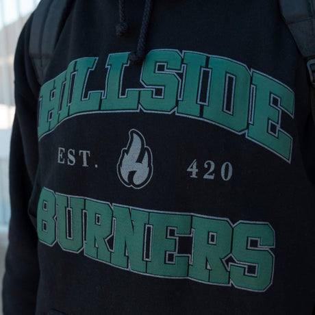 Black varsity hoodie chest logo with green arched text, flame icon, and Est. 420