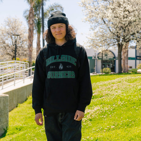 Black varsity hoodie with green arched 'Burners' print and Est. 420, worn with jeans