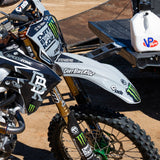 Dirt bike decal on white front fender with black script and neon green accents