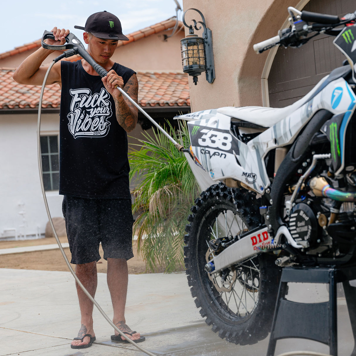 Black mens tank top with "Fuck your Vibes" graphic, worn by a person
