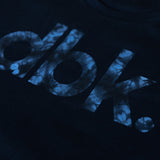 Basic Woodie tank top close-up of blue distressed “dirt bike” lettering on black fabric