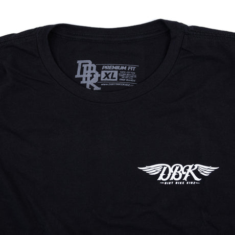 Black tall tee close-up of neckline and small winged DBK logo on chest