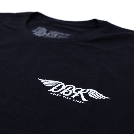 Black tall tee with small winged DBK logo print on the chest