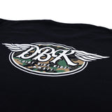 Black tall tee close-up with large winged DBK emblem featuring camo-style center