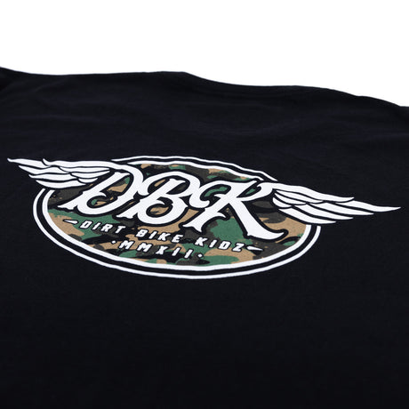 Black tall tee close-up with large winged DBK emblem featuring camo-style center