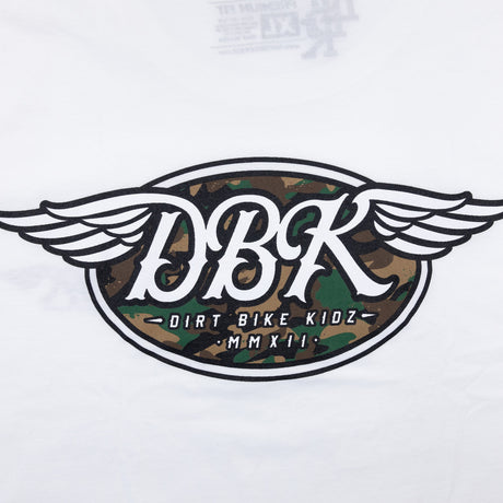 White tall tee close-up with large winged DBK emblem and camo-style graphic center