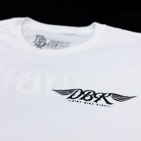 White tall tee with crew neck and small winged DBK logo printed on chest