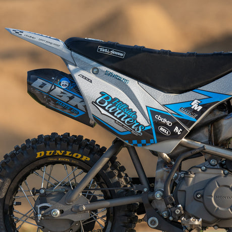 Motocross bike side panel with blue, black, and white decals and number-style graphics