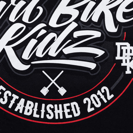 Close-up of logo text and crossed shovels on the tall tee graphic