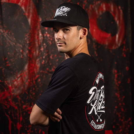 Black tall tee side view with graphic on sleeve and chest