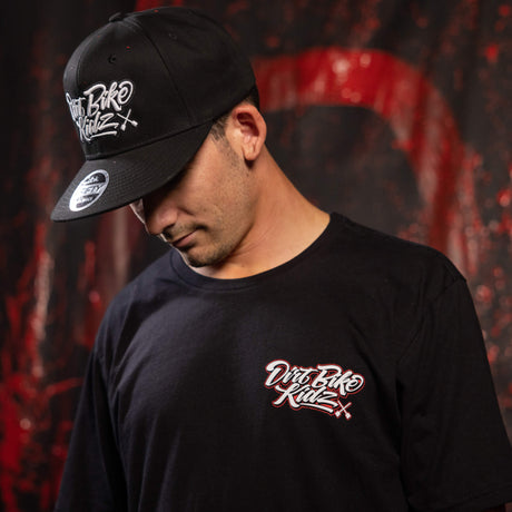Black tall tee worn with small chest logo graphic