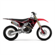 Off-road motorcycle graphic kit on black and red bike, gold fork, white wheels