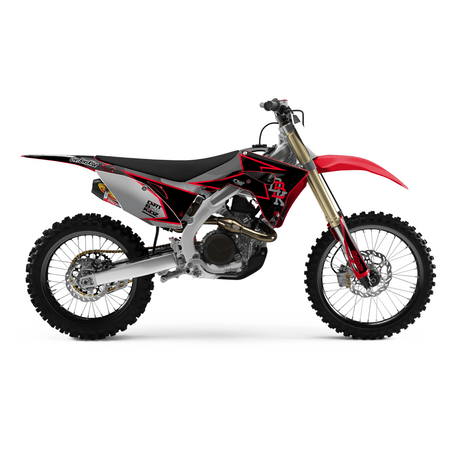 Off-road motorcycle graphic kit on black and red bike, gold fork, white wheels