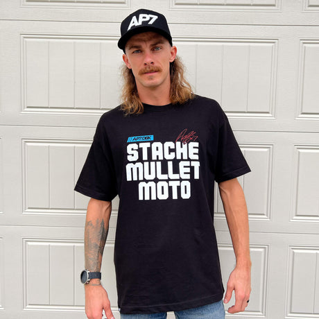Black crewneck graphic tee worn by model, front “STACHE MULLET MOTO” print