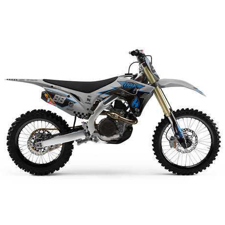 Off-road dirt bike left-side view in blue and gray with black seat and decals