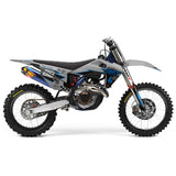 Blue and gray motocross motorcycle in side view with front fender and side graphics