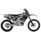 Off-road motorcycle side view with blue and black graphics on the panels and fenders