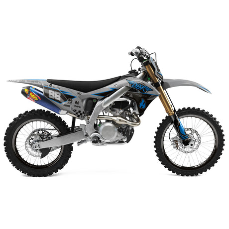 Off-road motorcycle side view with blue and black graphics on the panels and fenders