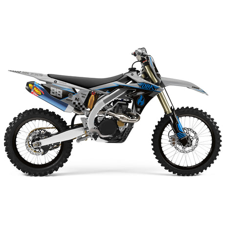Dirt bike side view with blue and gray graphics, number 88, and knobby tires