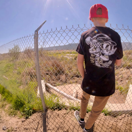 Youth black premium tee with large back skull and helmet graphic