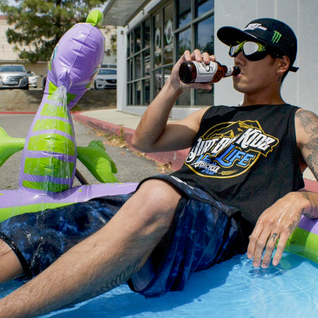 Black tank top with 'High Life' dirt bike graphic, worn by person near pool